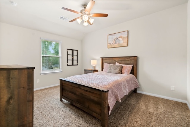 carpeted bedroom with ceiling fan and vaulted ceiling