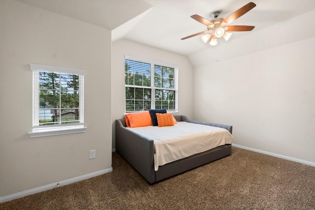 carpeted bedroom with multiple windows, lofted ceiling, and ceiling fan