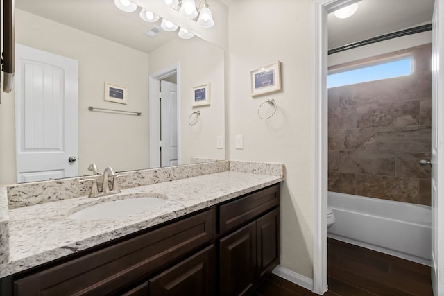 full bathroom featuring vanity, toilet, wood-type flooring, and bathing tub / shower combination