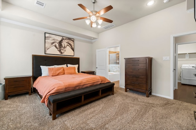 bedroom featuring carpet flooring, ceiling fan, washer / dryer, and ensuite bath