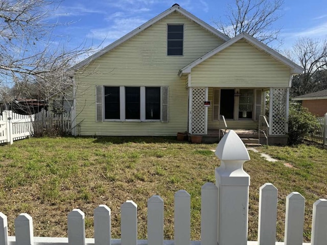 bungalow-style home featuring covered porch and a front yard