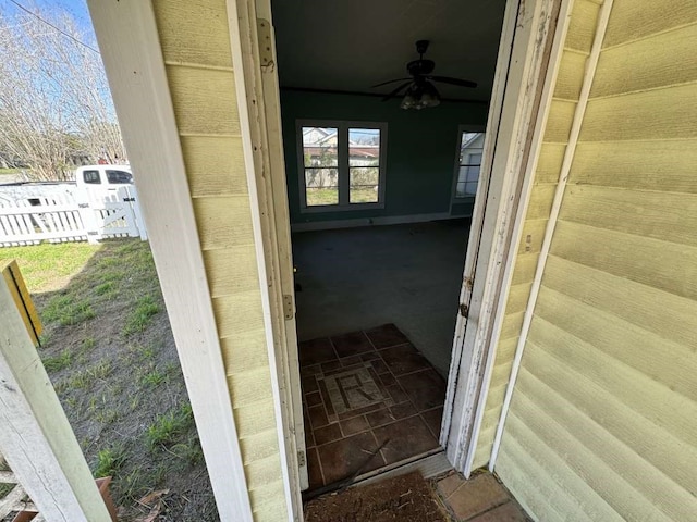 entrance to property featuring ceiling fan