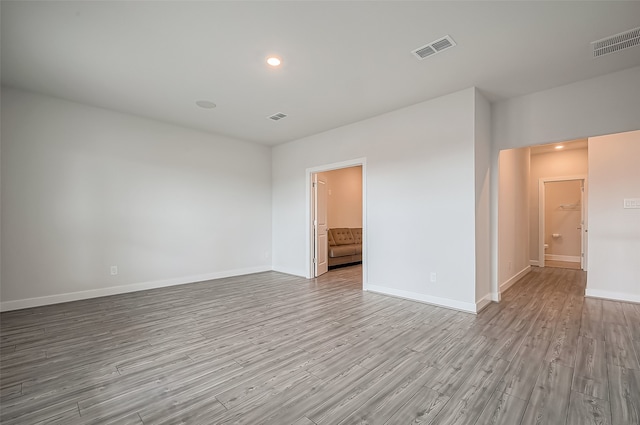 empty room with light hardwood / wood-style flooring