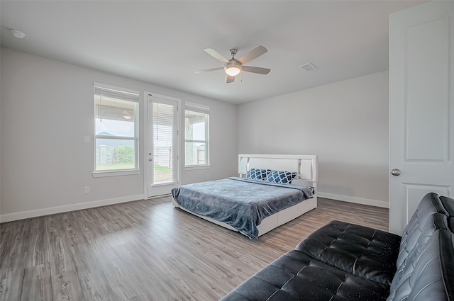 bedroom with light wood-type flooring and ceiling fan