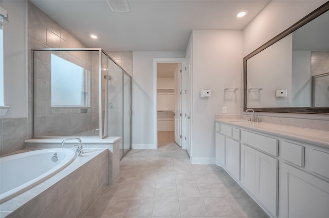 bathroom with independent shower and bath, vanity, and tile patterned flooring