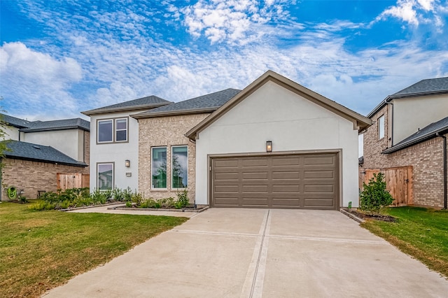 view of front of house with a front yard and a garage