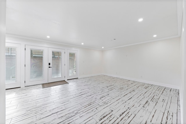 unfurnished room featuring french doors and crown molding