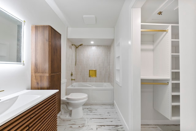 full bathroom featuring tiled shower / bath, vanity, and toilet