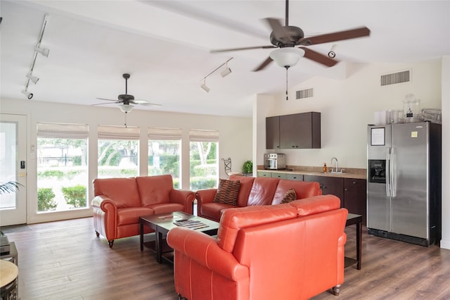 living room featuring sink, ceiling fan, vaulted ceiling, and hardwood / wood-style floors