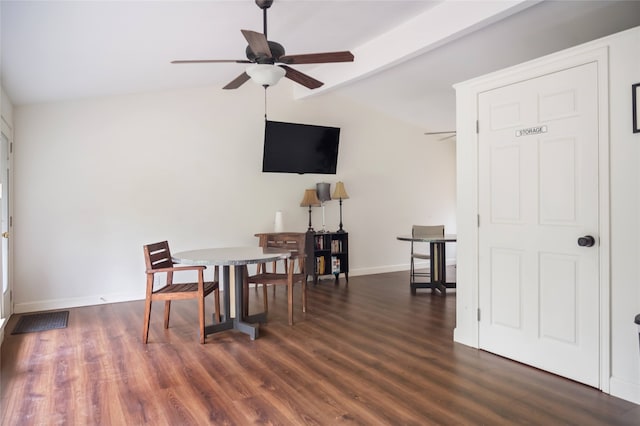 dining room with dark hardwood / wood-style floors, ceiling fan, and vaulted ceiling