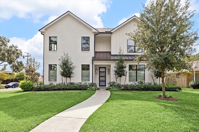 modern farmhouse style home featuring a front lawn