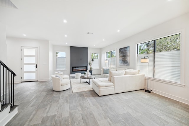 living room with light hardwood / wood-style flooring and a fireplace