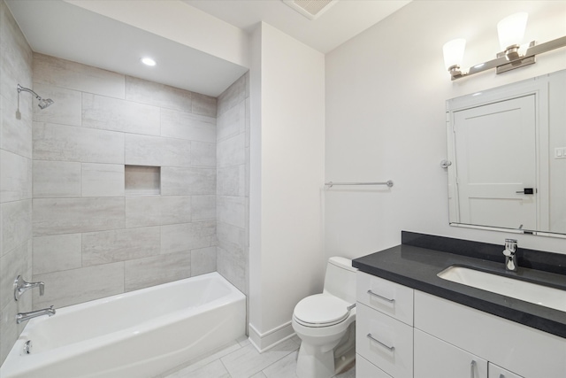 full bathroom featuring toilet, tiled shower / bath combo, and vanity