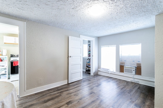 unfurnished bedroom with cooling unit, a closet, and dark hardwood / wood-style flooring