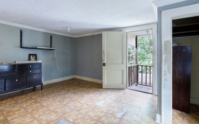 interior space featuring ornamental molding and a textured ceiling