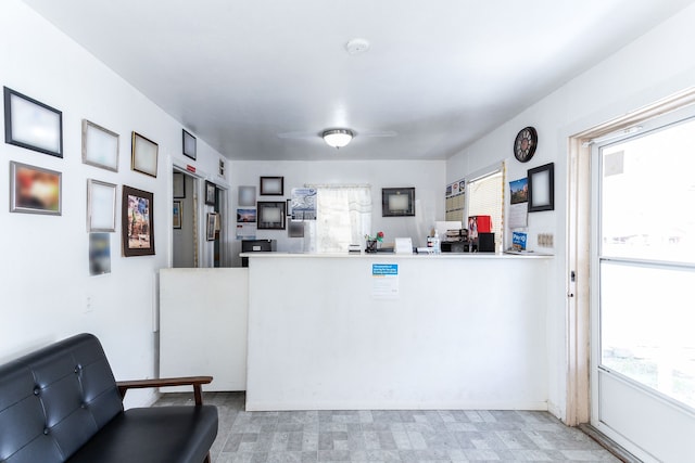 interior space featuring kitchen peninsula and plenty of natural light