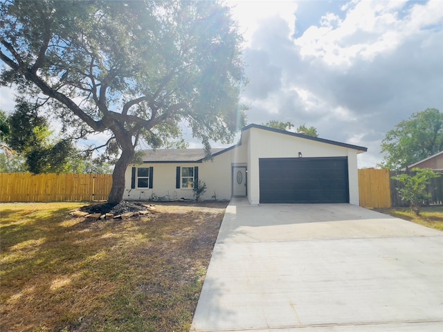 ranch-style home with a front lawn and a garage