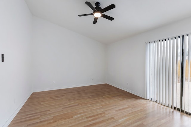 spare room with ceiling fan and light wood-type flooring