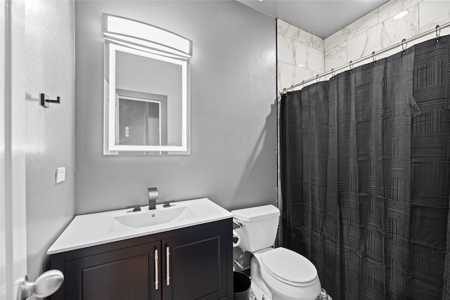 bathroom with vanity, toilet, and curtained shower