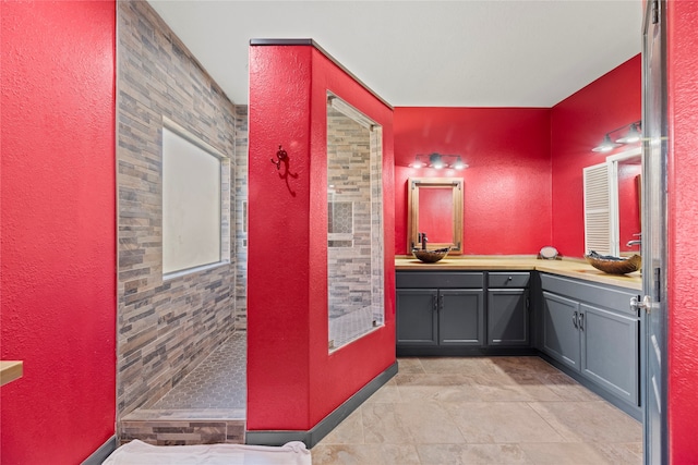 bathroom featuring vanity, tile patterned flooring, and walk in shower