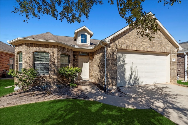 view of front of property featuring a front yard and a garage