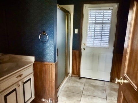 doorway to outside with light tile patterned flooring