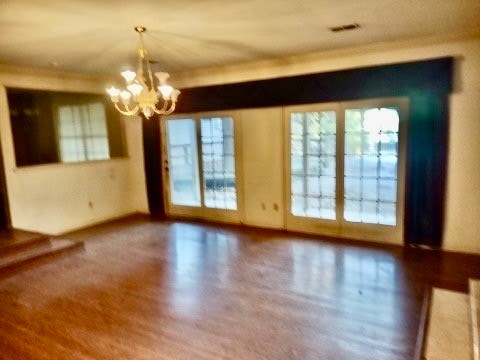 interior space featuring wood-type flooring and a chandelier