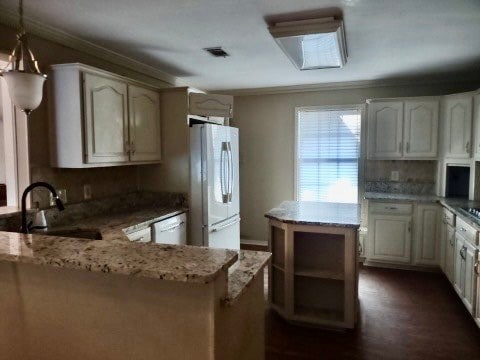 kitchen with sink, white cabinetry, pendant lighting, and white appliances