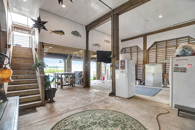 foyer featuring beam ceiling and high vaulted ceiling