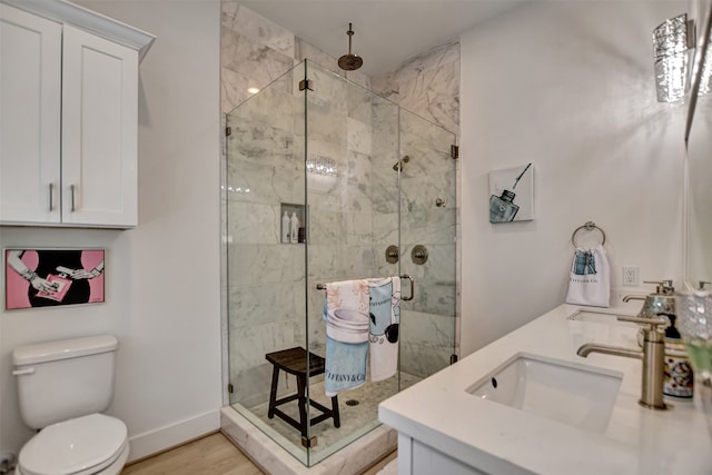 bathroom with vanity, toilet, an enclosed shower, and hardwood / wood-style floors