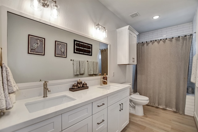 bathroom with vanity, a shower with shower curtain, wood-type flooring, and toilet