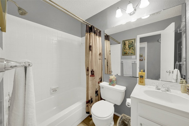 full bathroom with toilet, shower / bath combo, vanity, and a textured ceiling