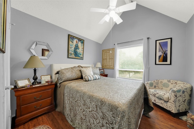 bedroom featuring dark hardwood / wood-style flooring, vaulted ceiling, and ceiling fan