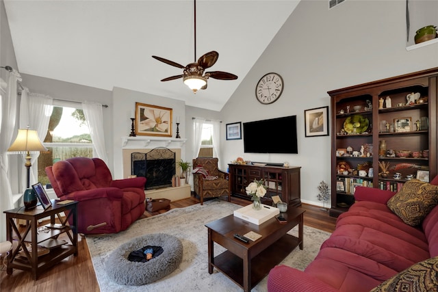 living room with high vaulted ceiling, hardwood / wood-style flooring, and ceiling fan