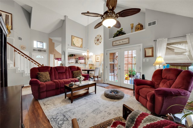 living room with high vaulted ceiling, hardwood / wood-style floors, french doors, and a healthy amount of sunlight