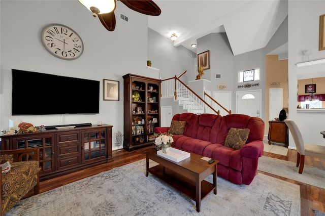 living room with high vaulted ceiling, hardwood / wood-style flooring, and ceiling fan