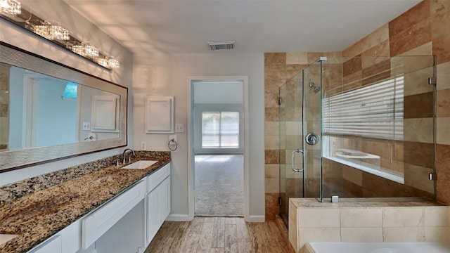 bathroom featuring vanity, shower with separate bathtub, and wood-type flooring