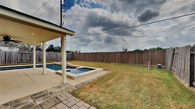 view of yard featuring a patio area, a fenced in pool, and ceiling fan