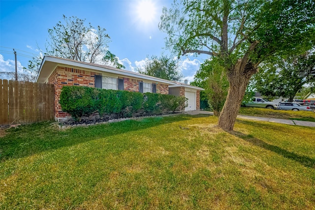 single story home featuring a front yard and a garage