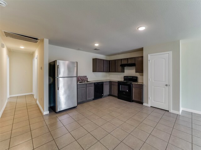 kitchen featuring dark brown cabinets, light tile patterned floors, and black appliances