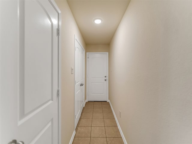 hallway featuring light tile patterned flooring