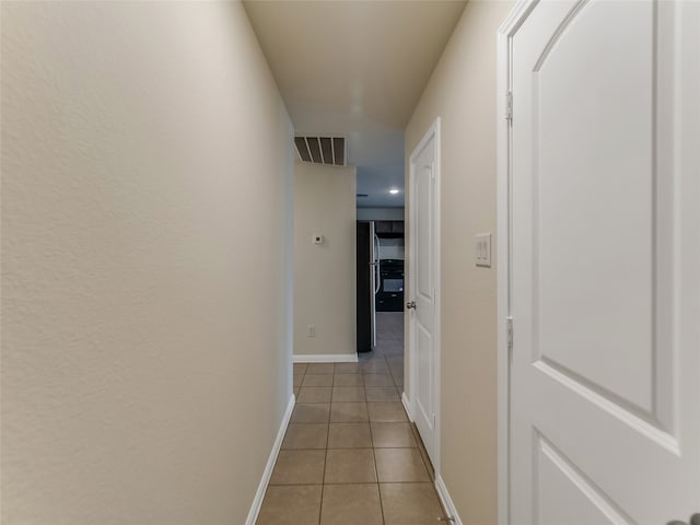 corridor with light tile patterned floors