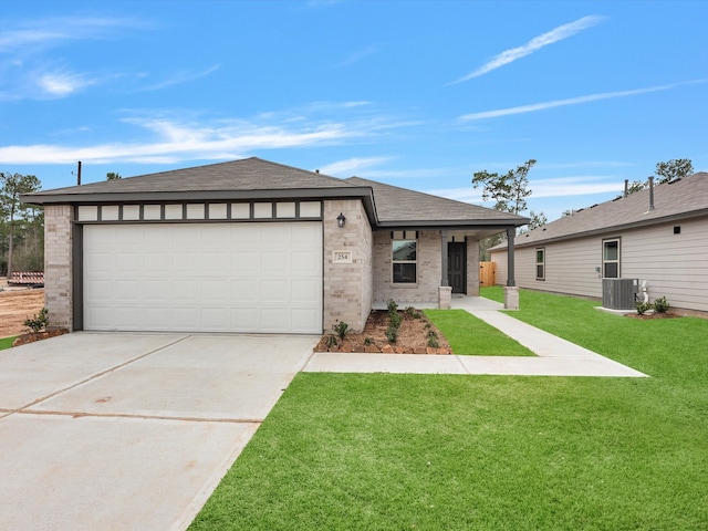 view of front of home featuring central AC, a garage, and a front lawn