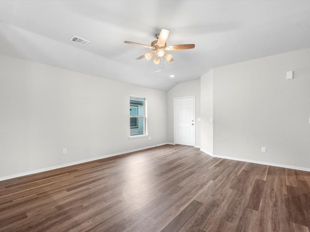 unfurnished room featuring lofted ceiling, dark hardwood / wood-style floors, and ceiling fan