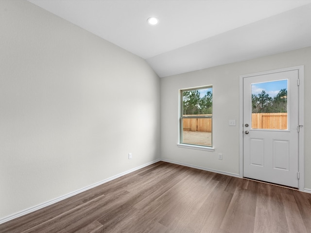 interior space with vaulted ceiling and hardwood / wood-style floors