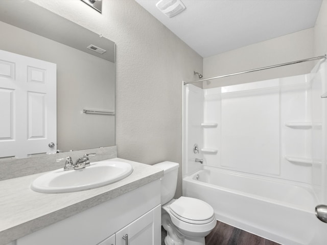 full bathroom with vanity, hardwood / wood-style flooring, toilet, and shower / bathtub combination