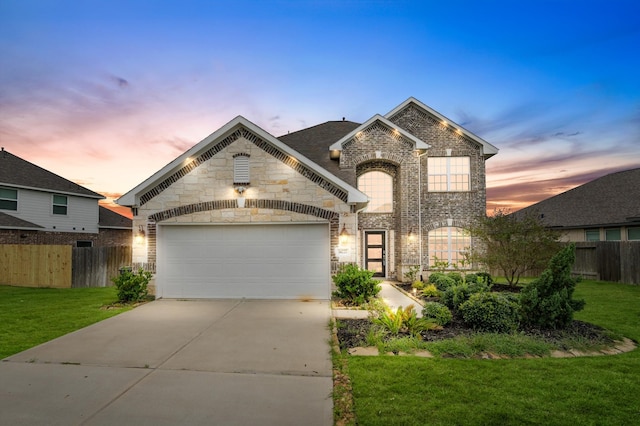 view of front of home with a yard and a garage