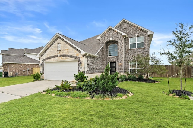 view of front of home with a garage and a front lawn