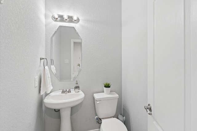 bathroom featuring toilet and sink