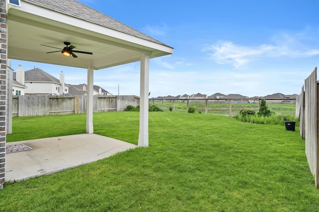 view of yard with a patio and ceiling fan